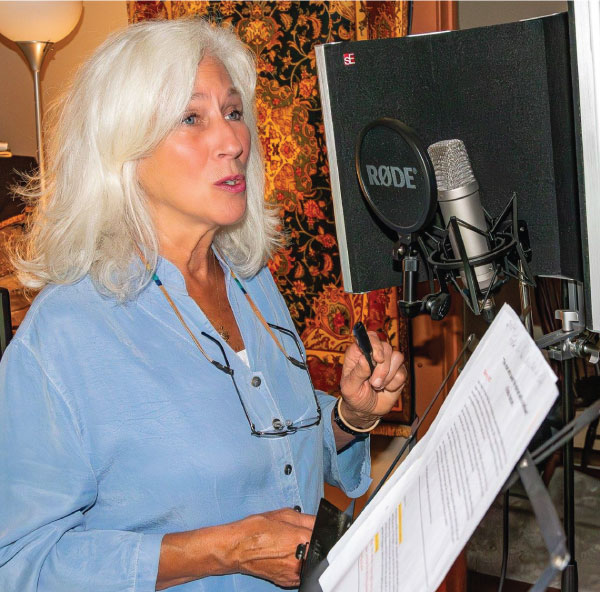 Voice Actor and narrator Kathryn Sheneman reading a script in her studio.